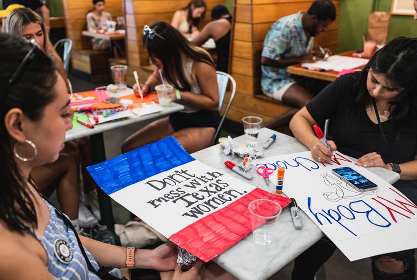 Activists make signs in preparation for an abortion rights rally with Democratic Gubernatorial Candidate Beto O’Rourke in East Austin on Jun. 26, 2022.